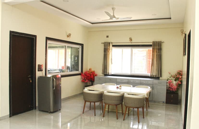 Bright dining room with window view and floral decor at Kokan Kinara Villa