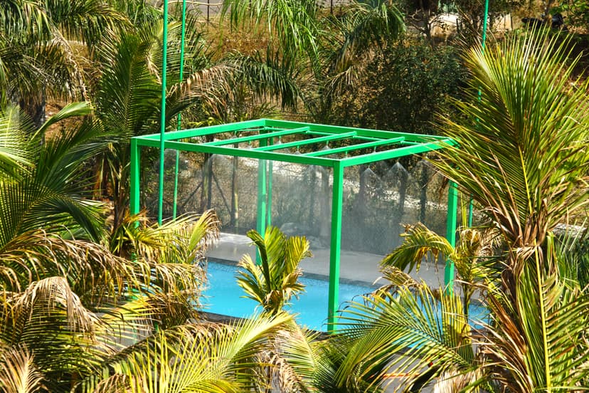 Private pool at Kokan Kinara Villa surrounded by lush palm trees