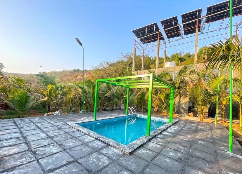 Private pool at Kokan Kinara Villa with green frame and solar panels in the background