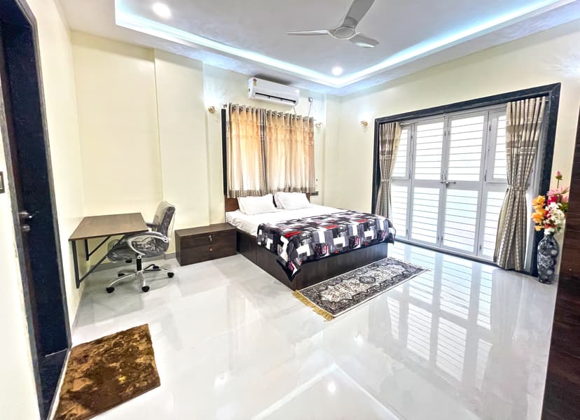 Spacious bedroom at Kokan Kinara Villa with elegant interiors and ample natural light