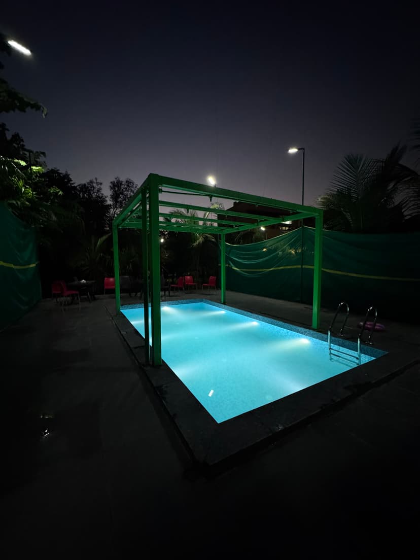 Dining area at Kokan Kinara Villa during evening with warm lighting and comfortable seating