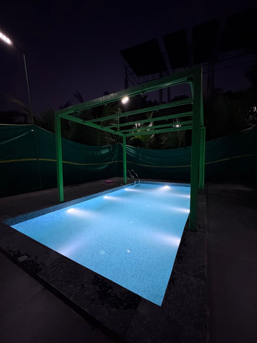 Night view of Kokan Kinara Villa pool area with beautiful lighting and serene atmosphere